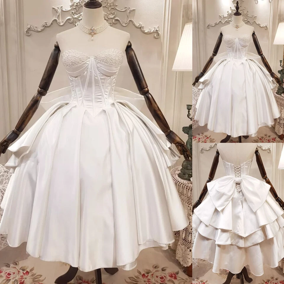 Vestidos de novia cortos de princesa con lazo satinado con cuentas sin tirantes Foto 1 de 4