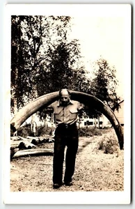 RPPC Postcard Man Holding Mammoth Tusk Alaska AK UNP - Picture 1 of 2