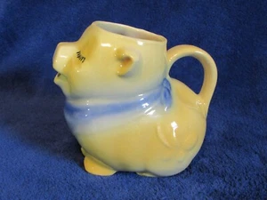 Jarra crema Shawnee Pottery Smiley Pig amarilla y azul - Imagen 1 de 8