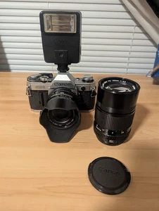 Canon AE-1 35mm SLR Film Camera w/ 135mm FD lens Flash And Sigma 28mm Lens Read - Picture 1 of 19