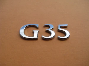 03 04 05 06 07 INFINITI G35 REAR TRUNK EMBLEM LOGO BADGE SIGN OEM USED A45941 - Picture 1 of 3