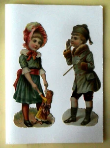 Dos restos troquelados vintage de cromos para niño y niña con imágenes de muñecas pegadas a tarjeta en blanco - Imagen 1 de 5
