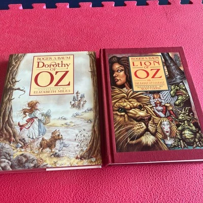 Two Roger S Baum Signed Books, Dorothy of OZ, HCDJ & Lion of Oz  HC - Image 1 of 4