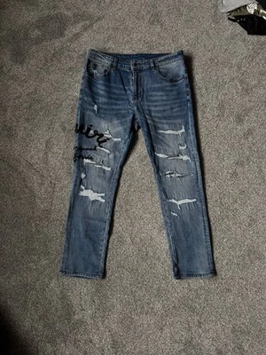 Pantalones de mezclilla rasgados Amiri para hombre - azul lavado, estilo callejero exclusivo talla: 32 Foto 1 de 4