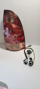 2005-2015 TOYOTA TACOMA PASSENGER SIDE TAILLIGHT WITH HARNESS  - Picture 1 of 3
