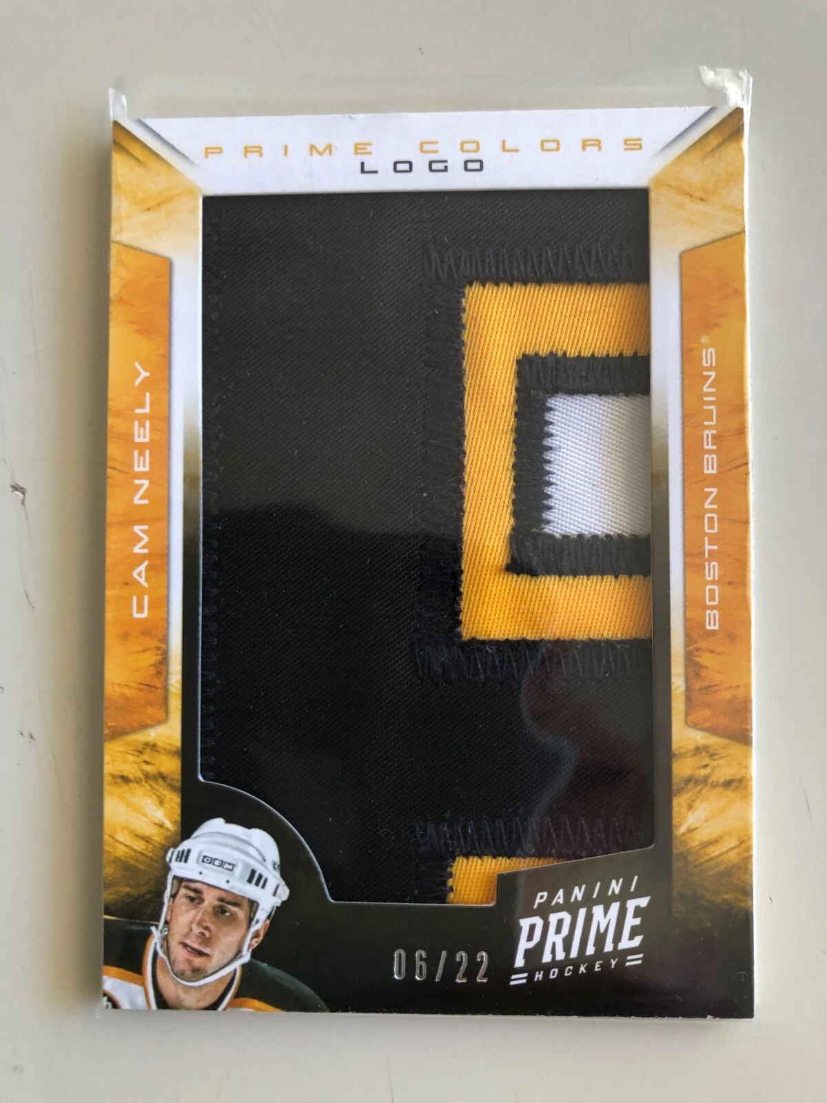 2012-13. PANINI PRIME COLORS LOGO PATCH. CAM NEELY. 06/22.