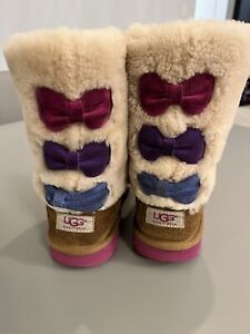 UGG MALENA BOOTS IN CHESTNUT COLOR WITH MULTI COLOR BOWS ON BACK. SIZE 3 KIDS