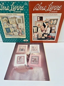 VTG Alma Lynne Cross Stitch Pattern Leaflets Cat Nursery Girl Sewing ~ Lot of 3 - Picture 1 of 5