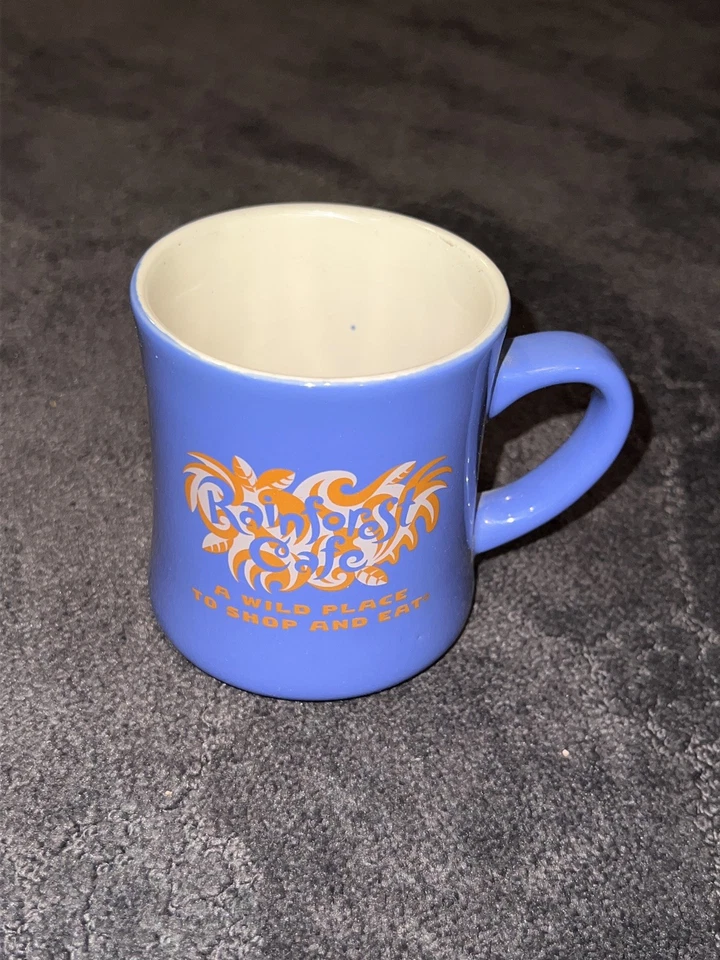  Taza Rainforest Café A Wild Place Vintage 1999 azul con beige  Foto 1 de 2