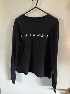 "CAMISETA: CAMISA GRANDE NEGRA GENUINA OFICIAL MANGA LARGA ""AMIGOS"" LOGOTIPO NIÑAS - Imagen 1 de 5