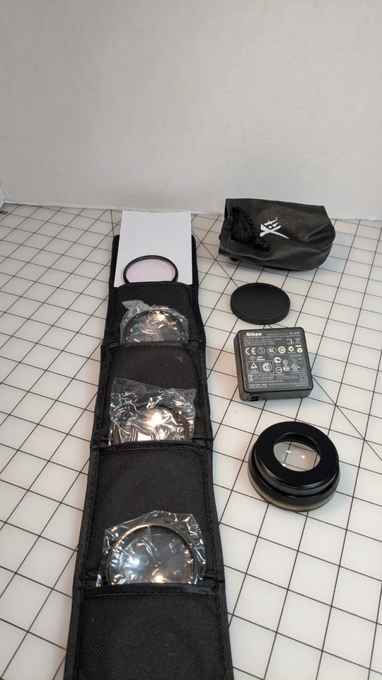 XIT Photo Lens Wallet/52 mm/4 Xit Close-up/ 1 Hoya Filter/1 Nikon EH-69P Charger - Image 1 of 4