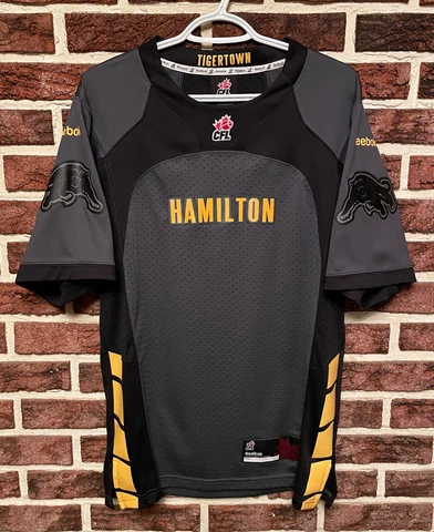 NEW Reebok HAMILTON TIGER-CATS Official CFL Football JERSEY Mens (S) Ti-Cats NEW Cover