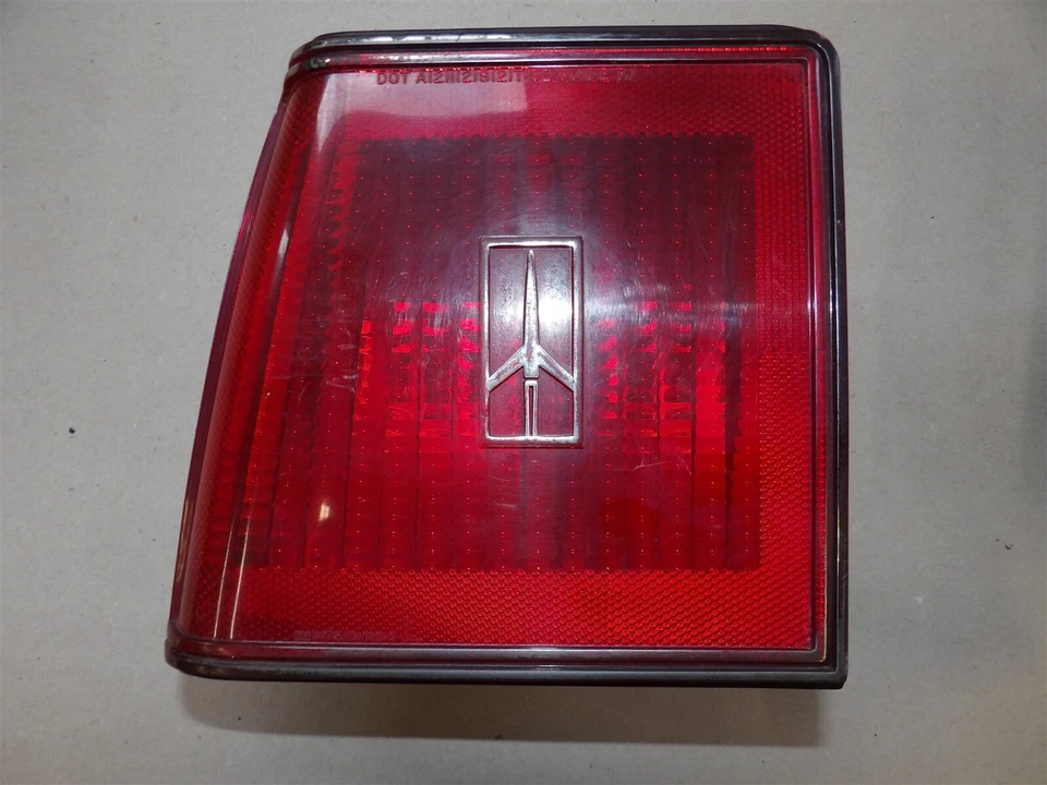 LH DRIVERS SIDE TAILLIGHT ASSEMBLY OLDSMOBILE FIRENZA 1982-84 4 DR SEDAN chrome - Image 1 of 4