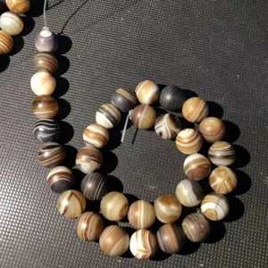 a strip ofMagic Tibetan Old Agate Natural Silkworm Line Totem dZi Round Bead12mm - Picture 1 of 8
