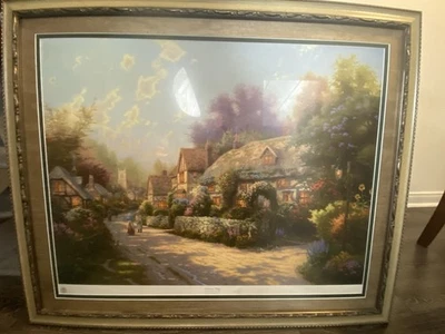 "Cobblestone Village" is a painting by Thomas Kinkade /34 inches W x 28 Inches H - Image 1 of 3