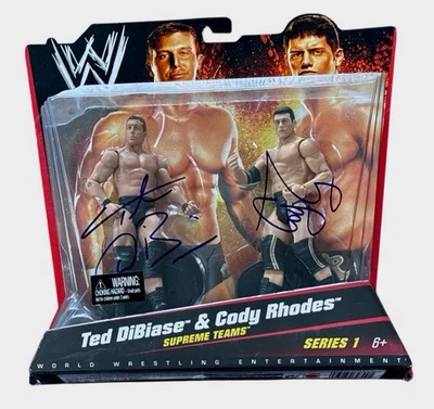 WWE CODY RHODES AND TED DIBIASE SIGNED SUPREME TEAMS 2 PACK WITH JSA COA RARE #1 - Image 1 of 2