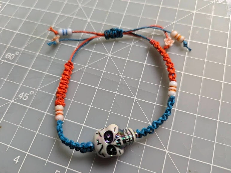Handmade braided friend ship bracelet "skull" blue and orange - Image 1 of 1