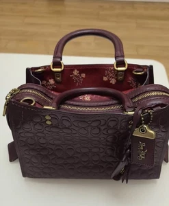 Coach 1941 Bordeaux Flower and Bow Brass Rogue 25 Bag - Picture 1 of 4