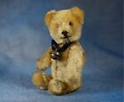 Old vintage brown teddy bear toy With a bell