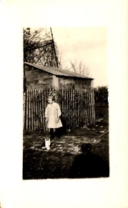 Postcard RPPC c1900s Young Girl In Dress Outside With Kitten By Shed In Yard - Picture 1 of 2