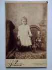 Young Child Holding Straw Hat & Doll Sitting In Rocking Chair  Cabinet Card
