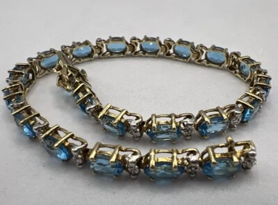 "Brazalete de tenis para damas de topacio azul natural y diamantes de oro amarillo macizo de 10 k 7""" Foto 1 de 4