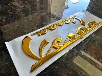 2 letras PIAGGIO "Vespa" capó lateral/placa de pierna 100/150 mm oro PX 80 125 - Imagen 1 de 3