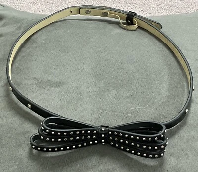 WOMAN’S THIN BLACK FAUX PATENT LEATHER BOW/STUDDED BELT BY W H B M-S - Image 1 of 4