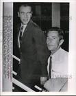 1963 Press Photo Lowell Skinner escorted through Idlewild Airport by Tony Dean.