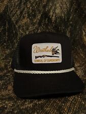 Weatherby Symbol of Superiority patch on a black ropebrim trucker hat