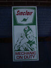 LARGE SINCLAIR GAS (SINCLAIR MECHANIC ON DUTY) 26" X 12" ADVERTISING WALL SIGN 