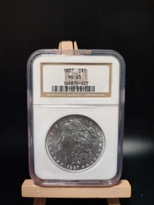 1887 Morgan Silver Dollar NGC MS 63 - Picture 1 of 5
