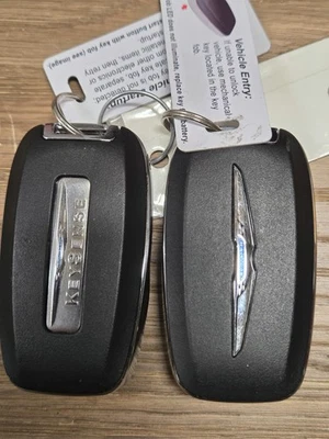 Lot of 2 Used OEM Chrysler Smart Keys.  Keys are cut. - Image 1 of 3