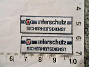   Menge 2 Vintage Interschutz Security Service Patch kostenloser Versand - Bild 1 von 1