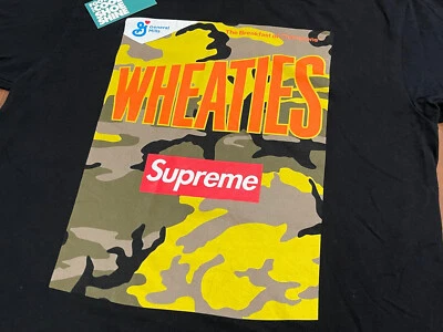 CAMISETA SUPREME GENERAL MILLS WHEATIES 2021 CEREAL CAMUFLAJE LOGOTIPO CAJA NEGRA DORADA M Foto 1 de 4