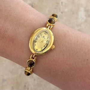 Reloj dorado estilo vintage delicado con banda de piedras preciosas ojo de tigre marrón cara ovalada para mujer - Imagen 1 de 8