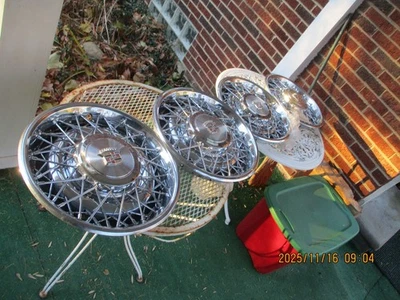 4 NOS 1980-1984 CADILLAC DEVILLE 15 INCH WIRE WHEEL COVERS WITH WRENCH AND LOCKS - Image 1 of 4