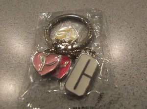 New in bag Clinique key chain holder has 4 decorative pieces attached - Picture 1 of 3