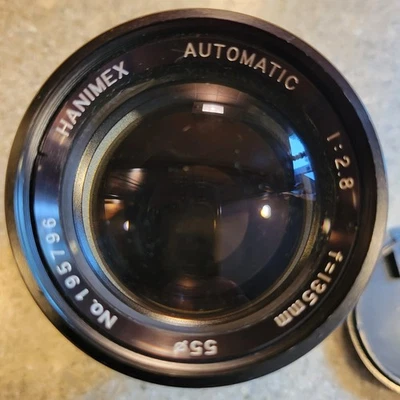 Lente teleobjetivo Hanimex automática 135 mm f/2,8 Nº 195756 y bolsa de transporte de cuero Foto 1 de 4