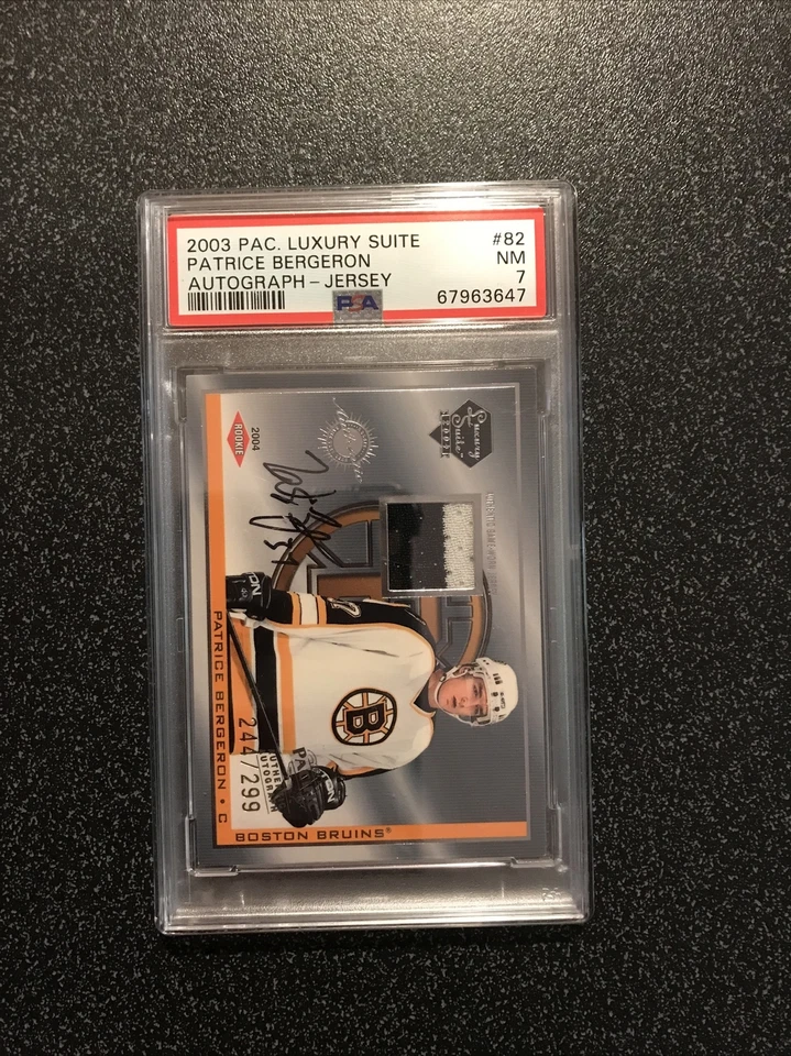 PATRICE BERGERON 2003-04 PAC Luxury Suite RC AUTO 2 CLR JERSEY SN#244/299 PSA 7 - Image 1 of 4
