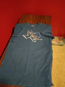 Medium Blue Fossil T-shirt That Says " Texas Auto Center Quotation Mark - Picture 1 of 2