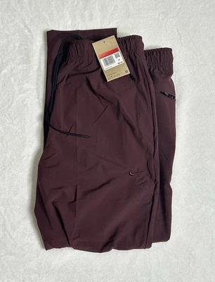 Pantalones cónicos Nike Unlimited Dri-FIT borgoña FB7546-652 para hombre talla L Foto 1 de 4