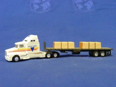 Ertl 4265 Kenworth T600B con remolque de plataforma plana y carga escala 1/87 HO fundido a presión sin usar, en caja Foto 1 de 2