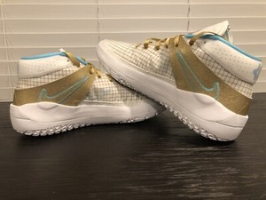 gold and white basketball shoes