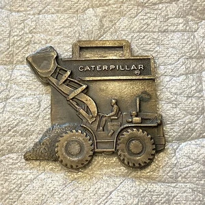 Caterpillar watch fob, metal, 1 1/2-inch x 1 1/2-inch . - Picture 1 of 2