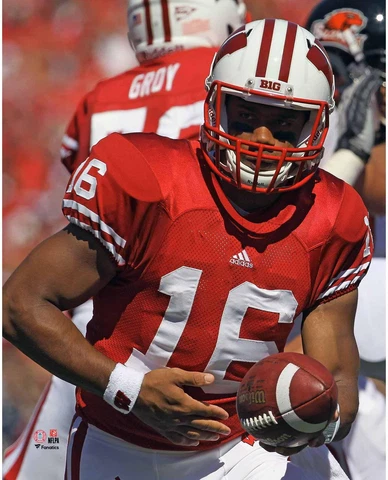 Russell Wilson Wisconsin Badgers Unsigned Red Jersey Handing Off Ball Photograph Cover
