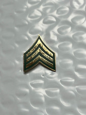 US ARMY SERGEANT E-5 BRASS ON OD GREEN BACKGROUND  HAT PIN MEASURES 1 INCH