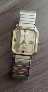 Cuarzo suizo ROGET años 80 para hombre-fecha-tono dorado-marcadores romanos-banda nueva-funciona muy bien - Imagen 1 de 10