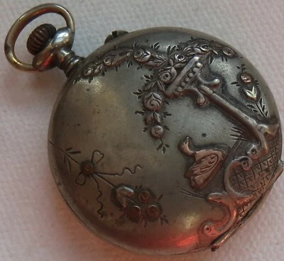 Small pocket watch white metal carved hunter case enamel dial balance Ok. - Image 1 of 4