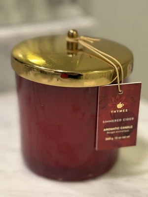 New THYMES Simmered Cider Candle 13 Oz Red Gold Apple Glass With Gold Lid - Image 1 of 3